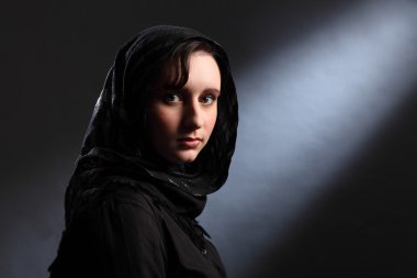 Young muslim woman in hijab has quiet moment clipart