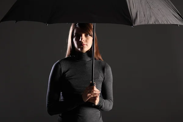 Stock image Shelter from trouble times woman under umbrella