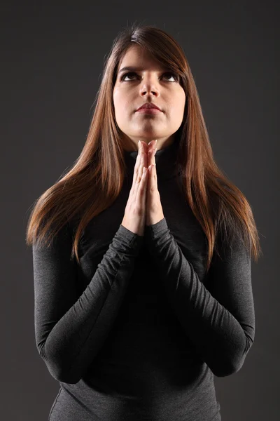Beautiful young religious woman looking up praying — Stock Photo, Image