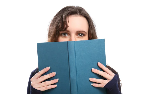 Woman looks up from reading a hard cover book — Stock Photo, Image