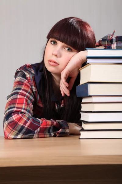 Cansada estudiante chica descansando en pila de libros —  Fotos de Stock