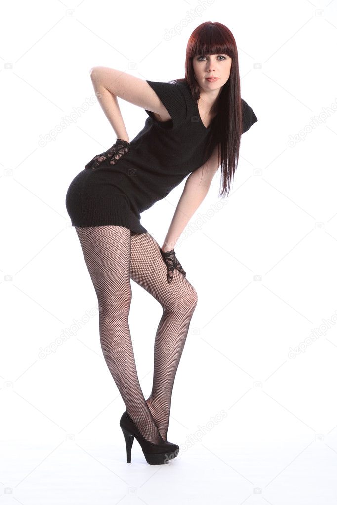 Sexy long legged model strikes pose in short dress