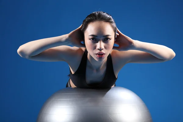 Oriental Asian woman back stretch on exercise ball — Stock Photo, Image
