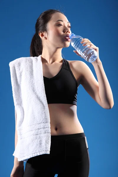 Chinese Asian girl drinking water after exercise — Stock Photo, Image