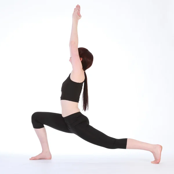 Guerrero de Yoga Una pose Virabhadrasana por mujer en forma —  Fotos de Stock