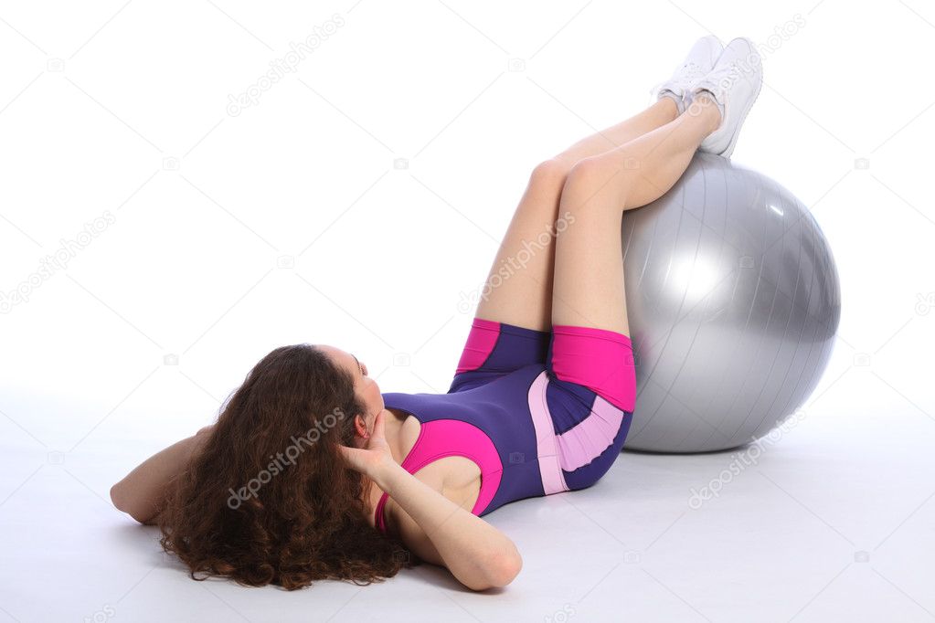 Fit young woman working out with exercise ball