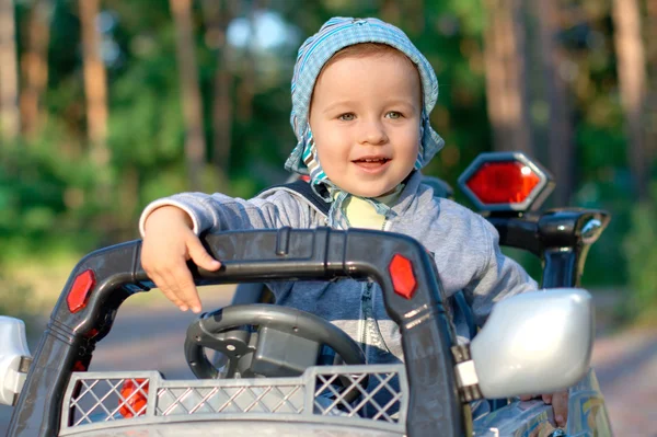 Baby at the toy car — Stock Photo, Image