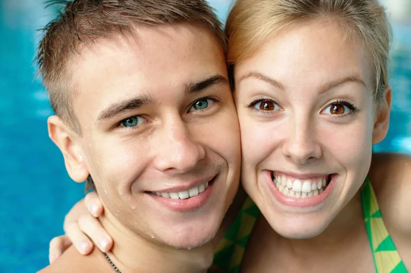 Smiling tenage couple at the swimming pool — Stock Photo, Image