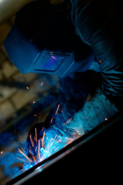 Close-up portrait of a welder at work