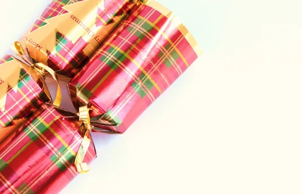 Close up traditional festive Christmas crackers in gold and red — Stock Photo, Image