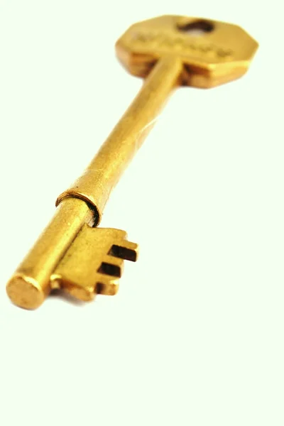 Vertical close up old gold key — Stock Photo, Image