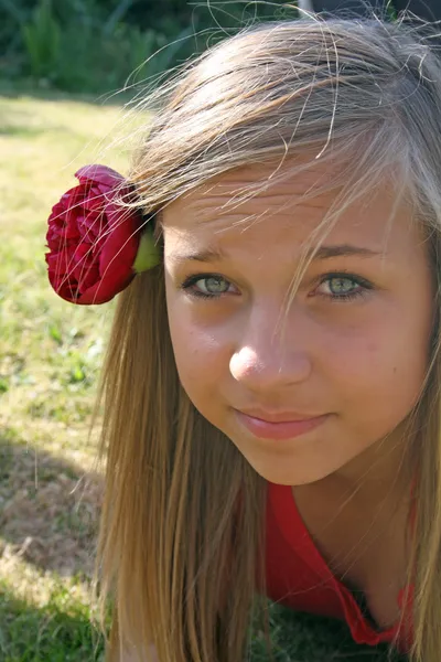 Teenage girl with flower in hair — Stock Photo, Image