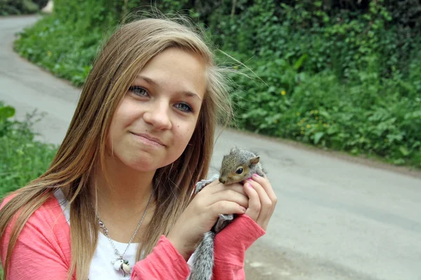 Teenage girl with a squirrel — Stock Photo, Image