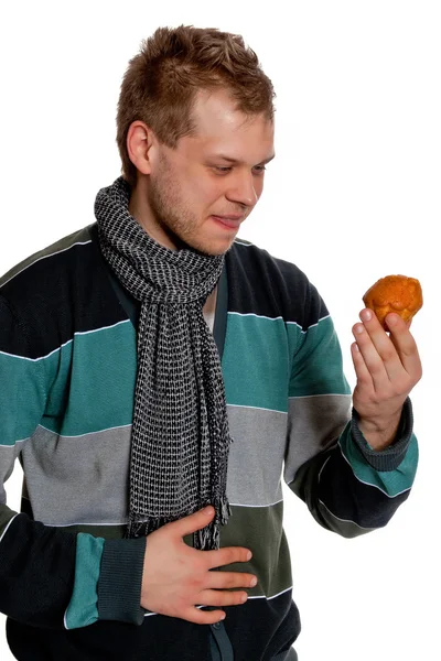 A young man keeps Tasty Cupcake — Stock Photo, Image
