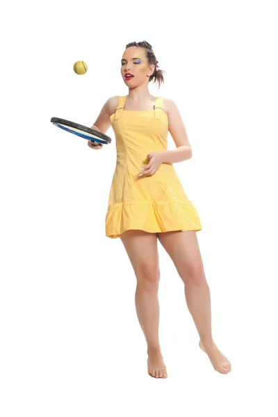 Girl in yellow with a tennis racket — Stock Photo, Image