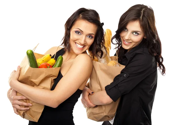 Dwie kobiety gospodarstwa artykuły spożywcze — Zdjęcie stockowe