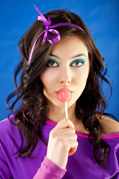 Woman licking lollipop — Stock Photo, Image