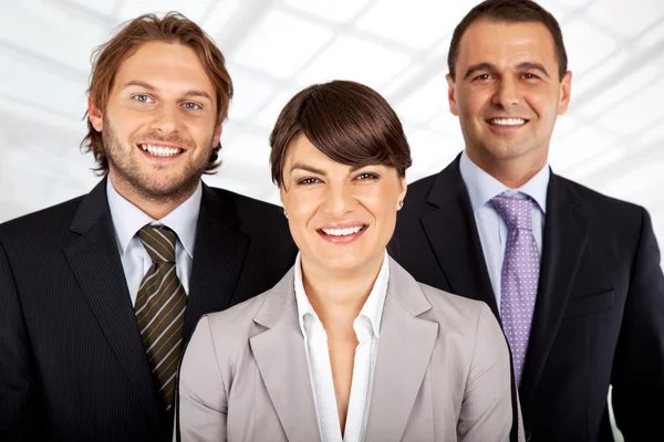 Equipe de negócios positiva de três — Fotografia de Stock