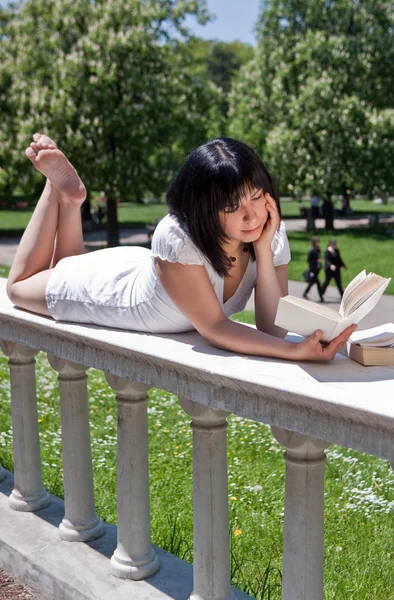 Студент читает книги в парке — стоковое фото