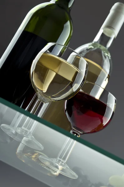 Wineglasses with two wine bottles — Stock Photo, Image