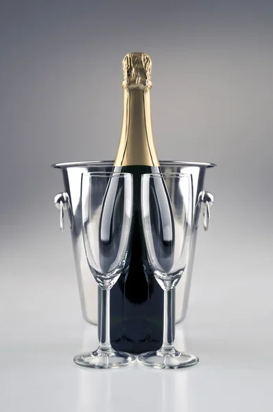 Champagne bottle with cooler and two champagne glasses — Stock Photo, Image