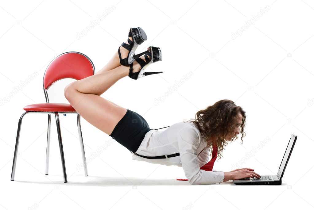Sexy businesswoman lying on chair with laptop