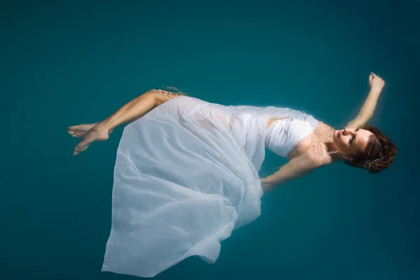 Ung sexig kvinna flyter på poolen — Stockfoto