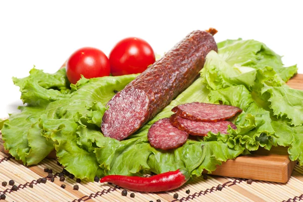 Salami with lettuce, garlic and tomatoes — Stock Photo, Image