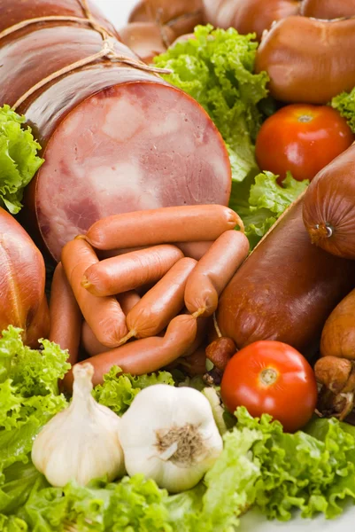 stock image Sausages and ham with lettuce, garlic and tomatoes