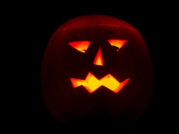 stock image Halloween pumpkin lit by candles