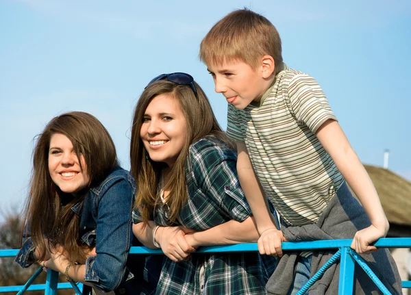 Twee jonge meisjes en een jongen lachen — Stockfoto