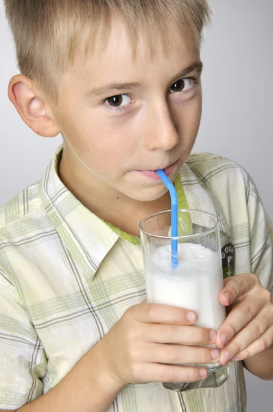 Smiling boy drinking milkshake — Stock Photo, Image