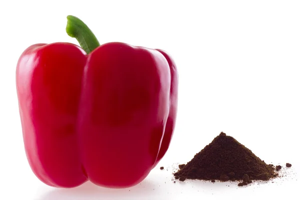 Red bell pepper and heap of paprika — Stock Photo, Image