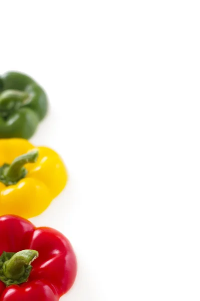Three colorful bell pepper tops with copy space, isolated — Stock Photo, Image