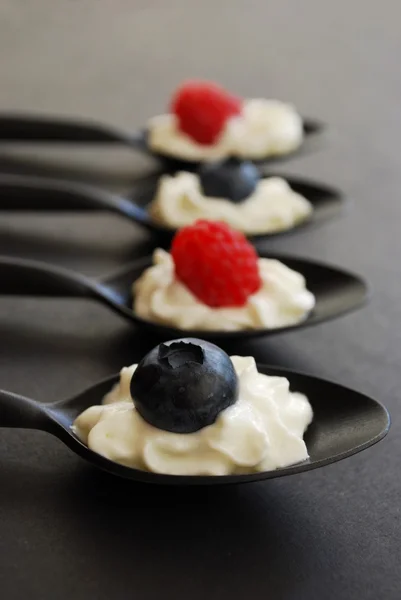 stock image Blueberries and raspberries with whipped cream