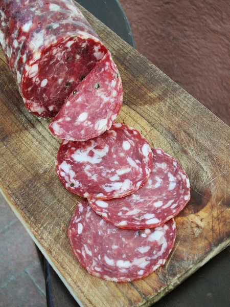 Round salami with slices — Stock Photo, Image