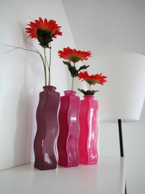 Gerbers in three vases clipart