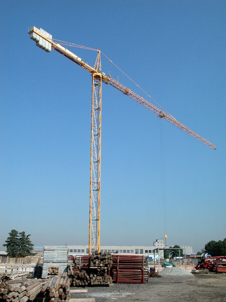 Crane in building yard for the construction of a building