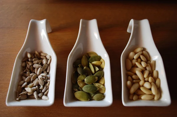 Seeds in ceramic containers — Stock Photo, Image