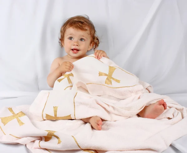 Smiling baby hidden in towel Royalty Free Stock Photos