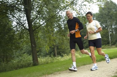 Senior Couple Running In The Woods clipart