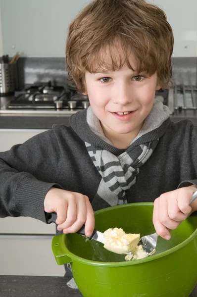 Boy making the dough for the cakes — Stock Photo, Image