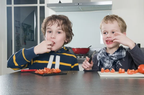 Boys tasting tomato — Stock Photo, Image