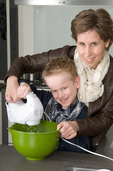 Mother and son mixing the dough — Stock Photo, Image