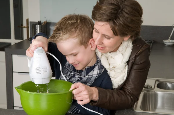 Mother and son mixing the dough — Stock Photo, Image