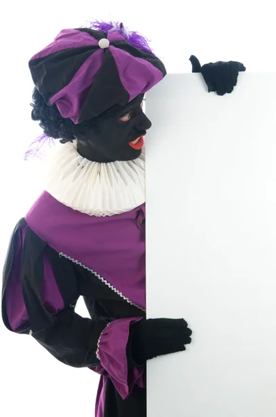 Zwarte Piet olhando para um quadro branco, para colocar o seu texto em . — Fotografia de Stock