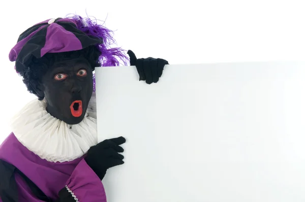Zwarte Piet guardando una lavagna bianca, per inserire il testo in . — Foto Stock