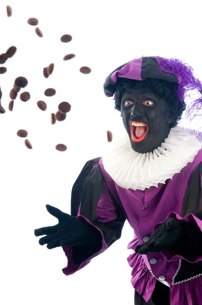 Zwarte Piet wirft Ingwernüsse — Stockfoto