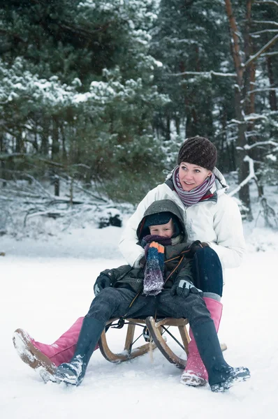 Boy and girl on a sled — Stock Photo, Image