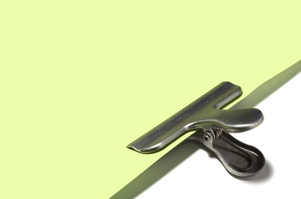 stock image Metallic paperclip on green paper